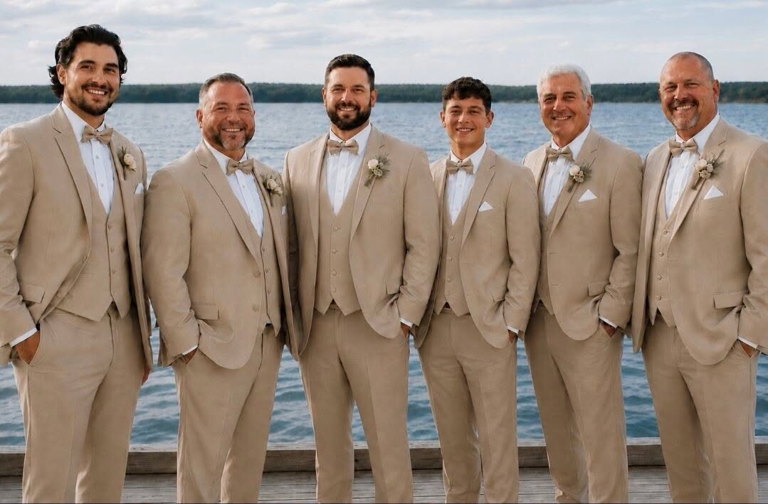 Groomsmen in coordinated tan suits by the water