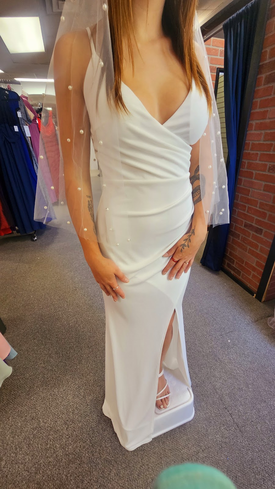 A fitted white gown with veil